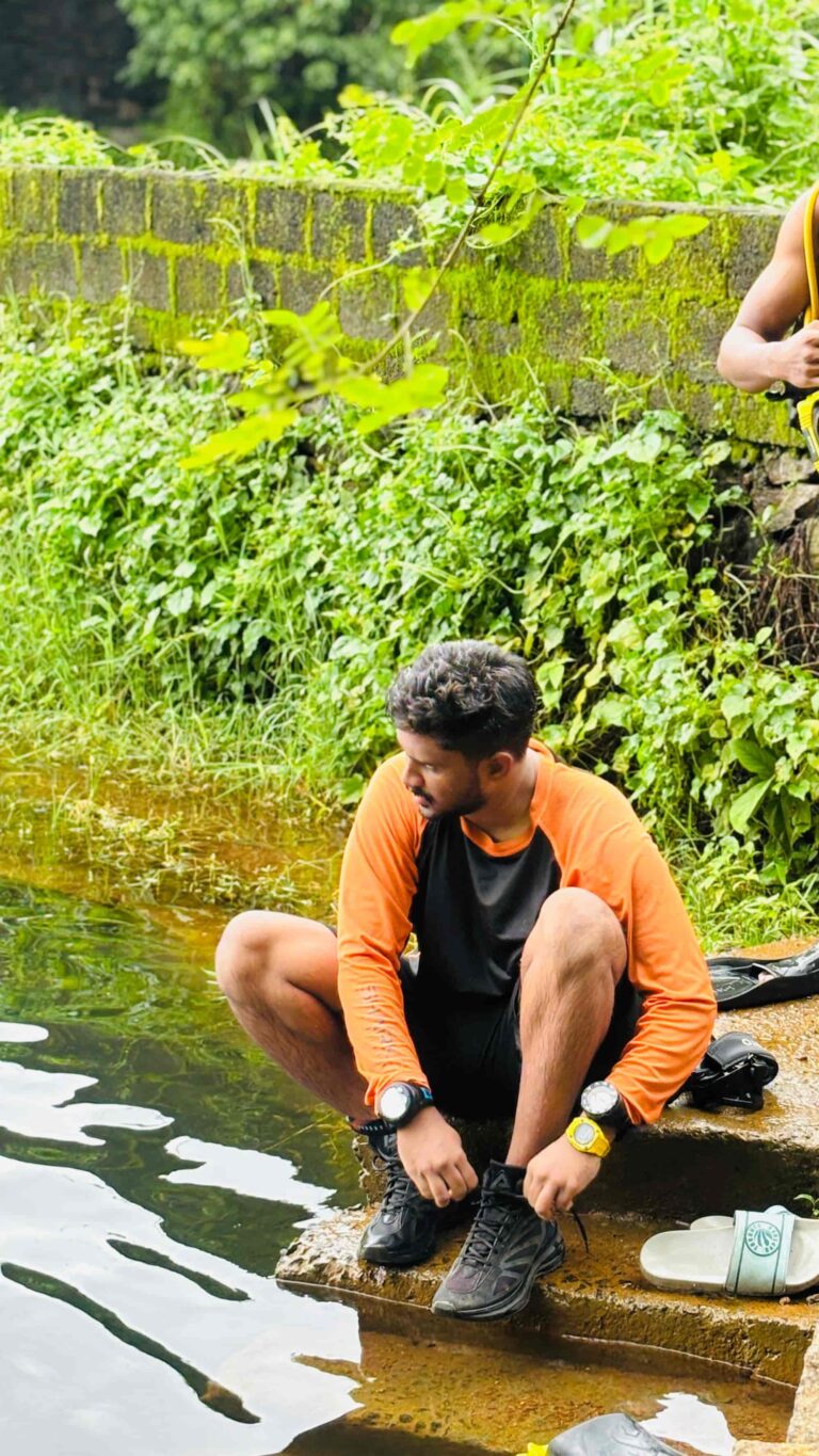 A scuba instructor sitting near a steps of a pound